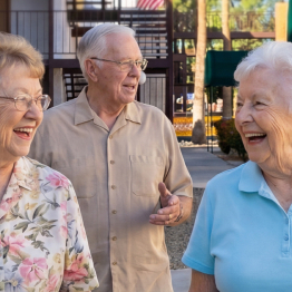 Senior ladies and man walking outside at Fellowship Square Independent Living community