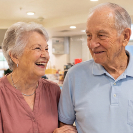 Senior couple smiling in the Cafe at Fellowship Square Independent Living community