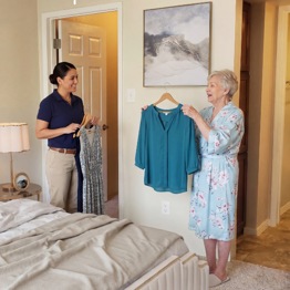 Caregiver With Resident Selecting Clothes 558Px Sq